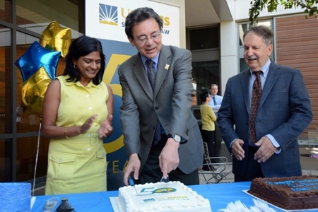 Deans Johnson and Sunder and former Dean Pershbacher serve cake