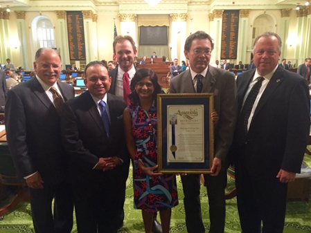 Deans Johnson and Sunder at State Capitol receiveing resolution