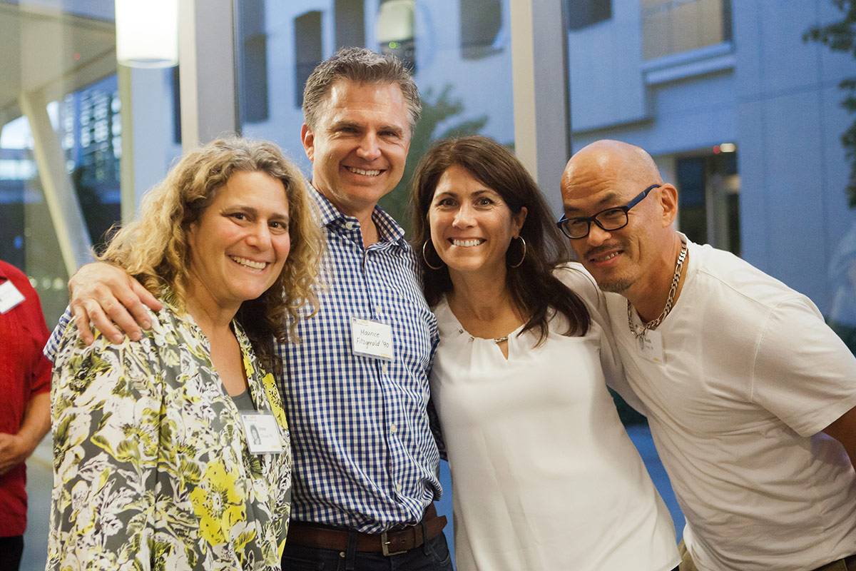 Four people smile for the camera