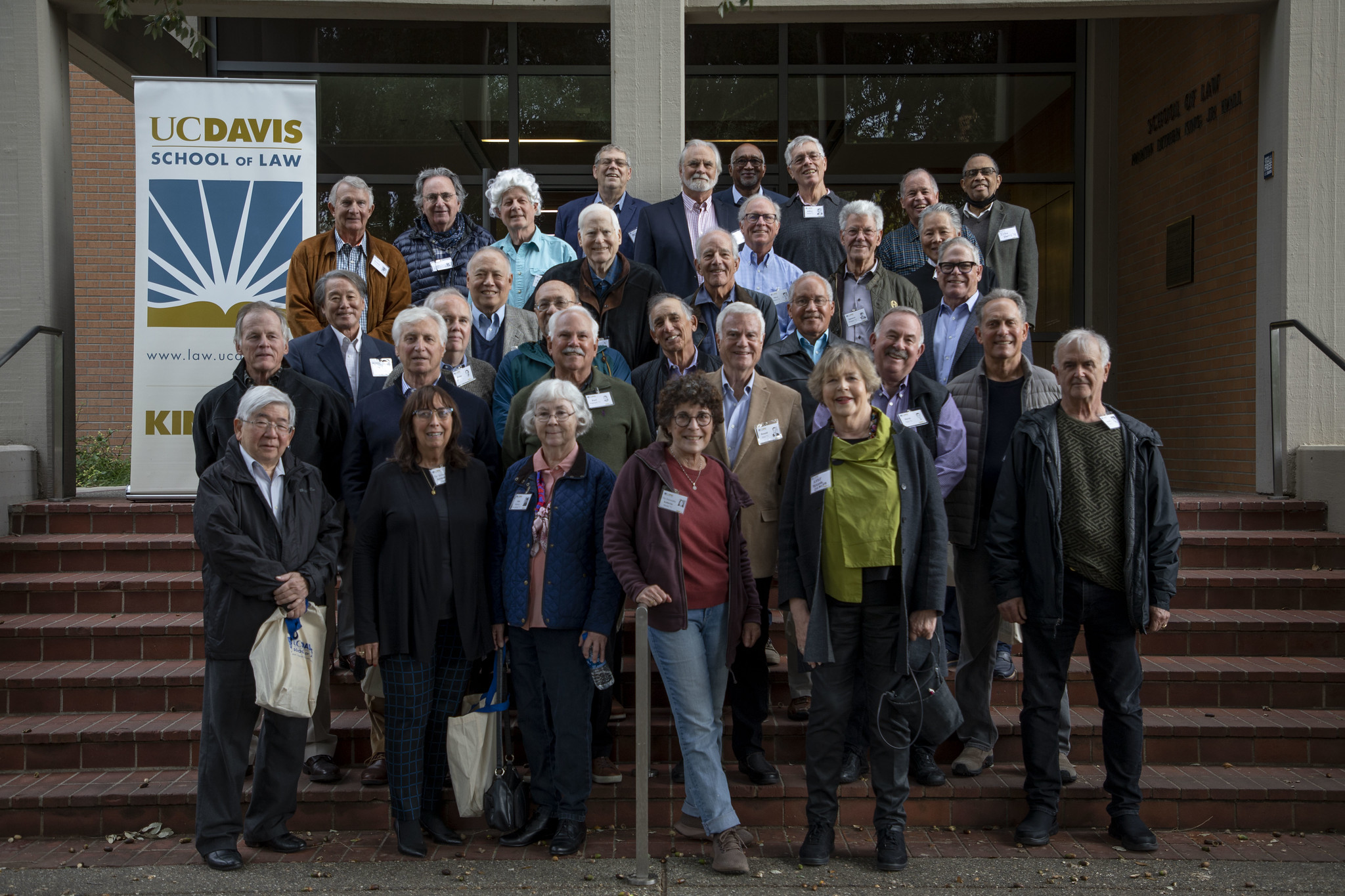 The UC Davis Law Class of 1972 standing on the steps in the front of King Hall.