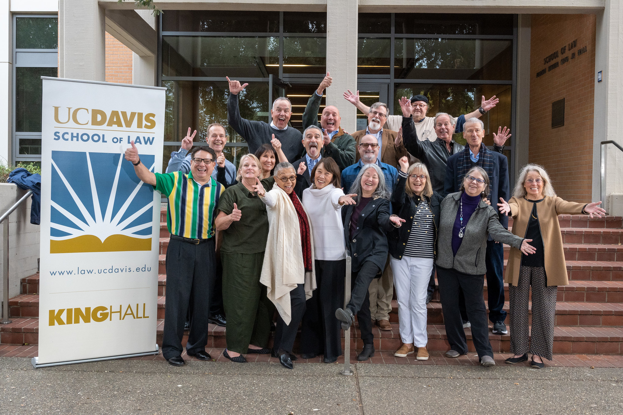 UC Davis Law's Class of 1982 standing in front of the steps of King Hall.