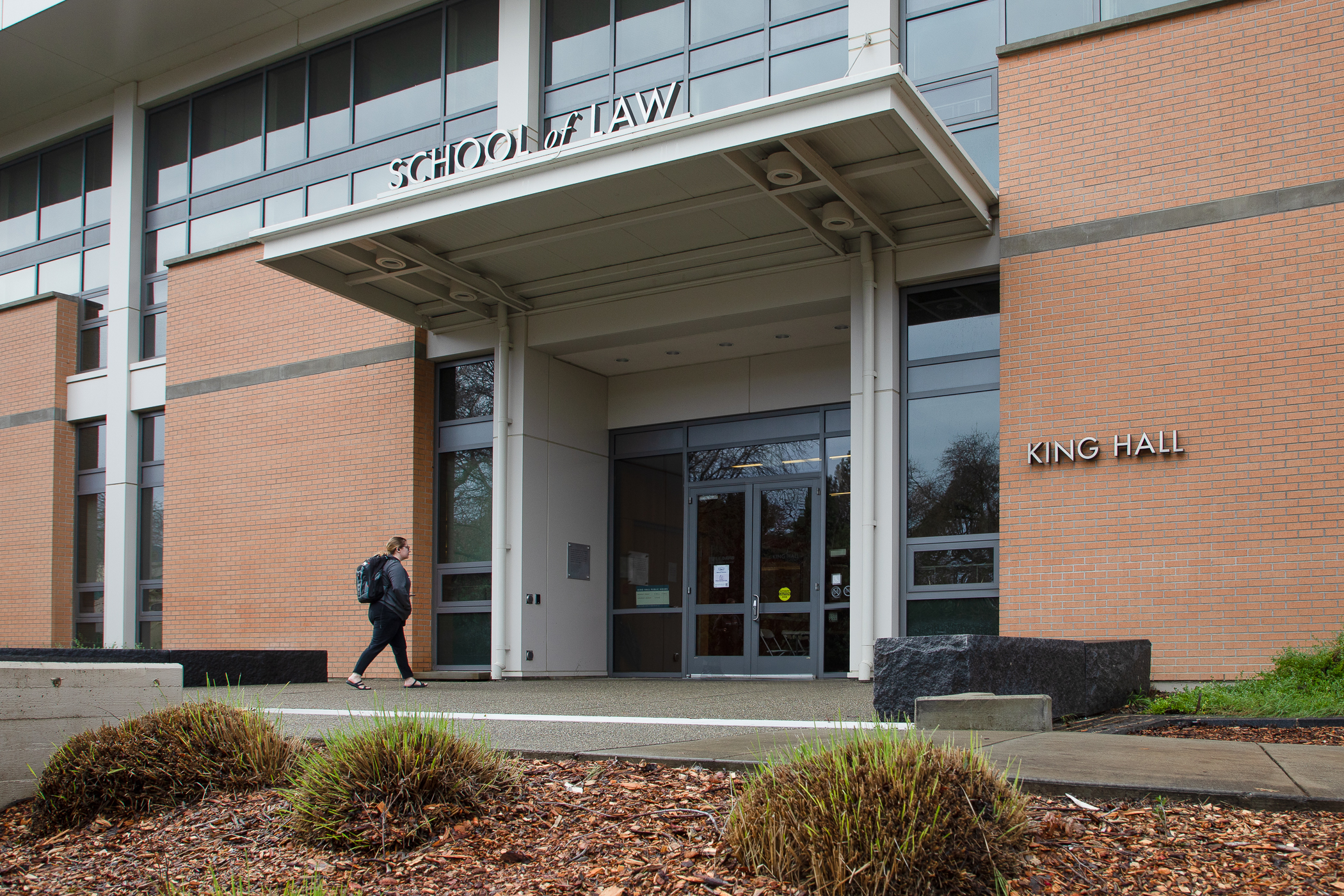 A UC Davis Law student walking into King Hall.