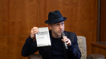 Jeff Cohen, a transactional entertainment lawyer, speaking to students at King Hall. He is holding his book, The Dealmaker's Ten Commandments.
