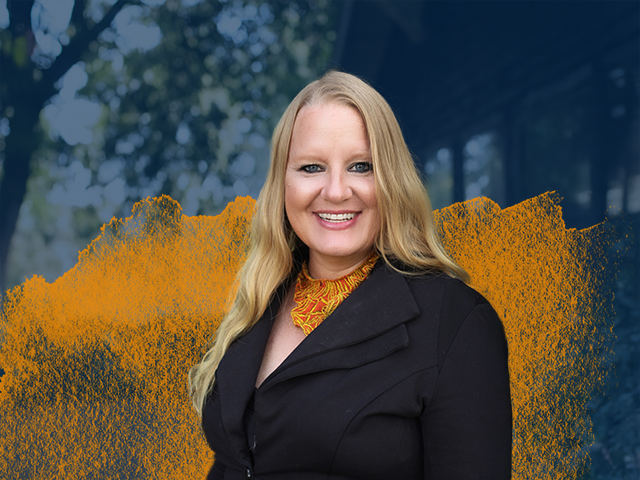 Professor Holly S. Cooper with a blue and orange gradient in the back of her portrait.