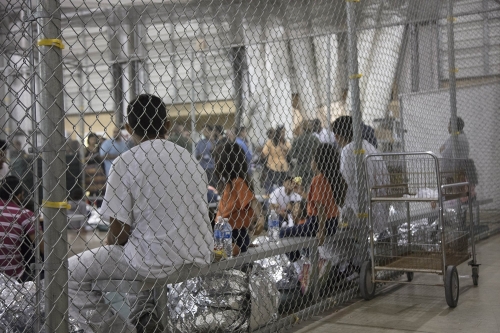 People sitting at the Ursula detention center in McAllen, Texas.