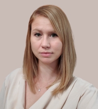 Raelene Dugger, UC Davis Law's Assistant Director of Development, in white. She is softly smiling at the camera.