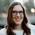 UC Davis Law Lecturer Nina Jehle wearing glasses and smiling at the camera.